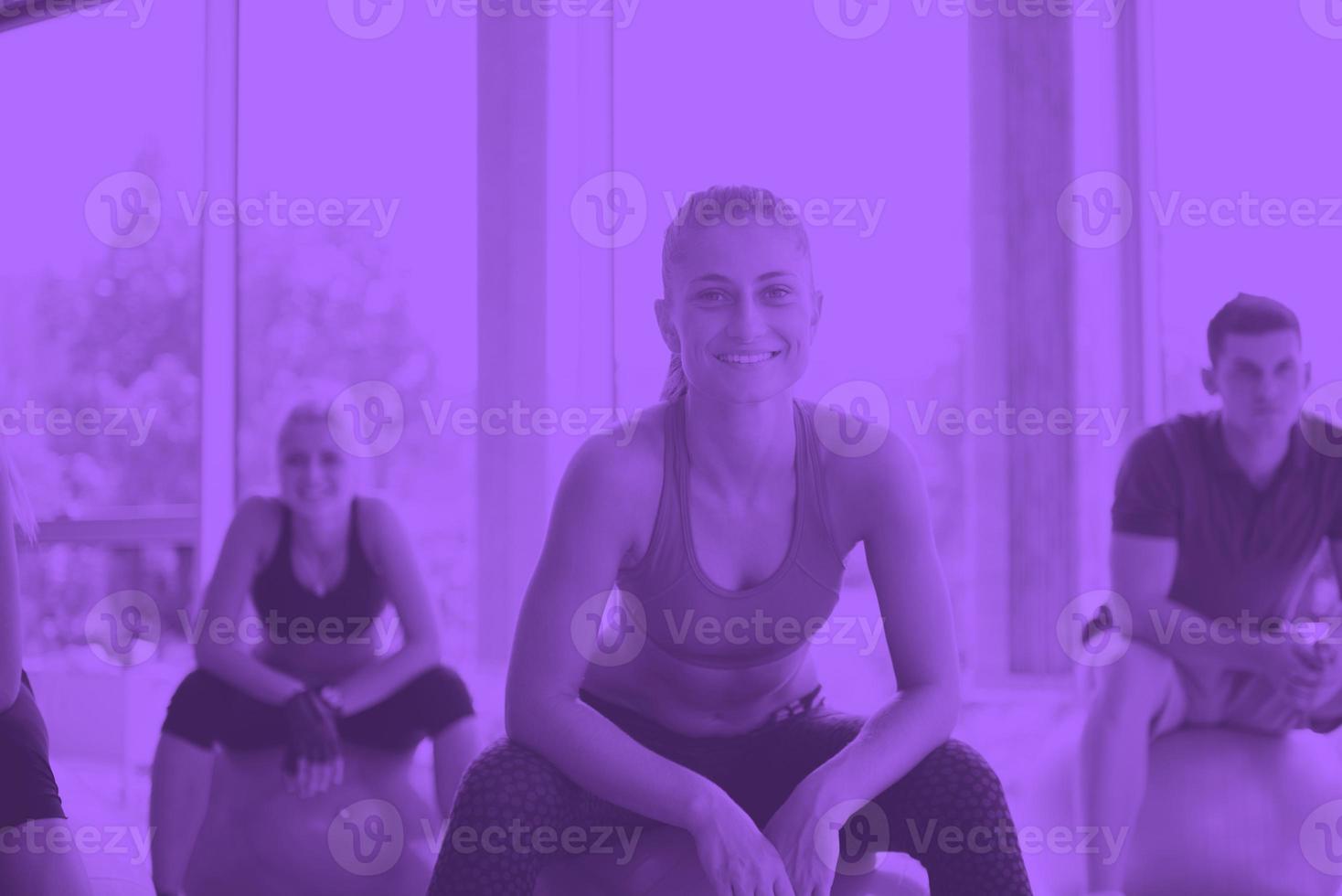 group of people exercise with balls on yoga class photo