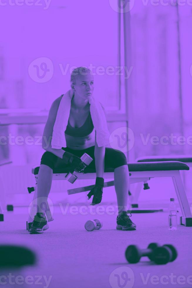 young woman exercise with dumbells photo