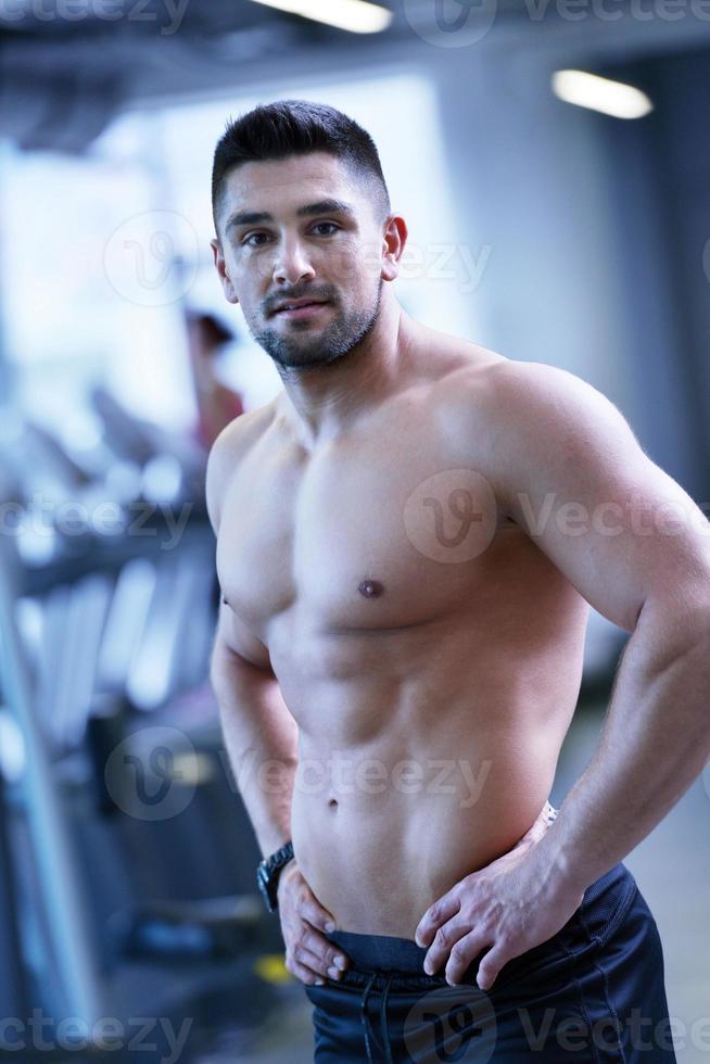 handsome man exercising at the gym photo