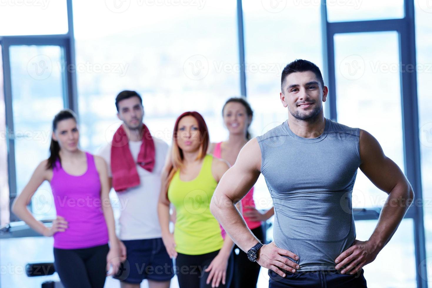 Group of people exercising at the gym photo