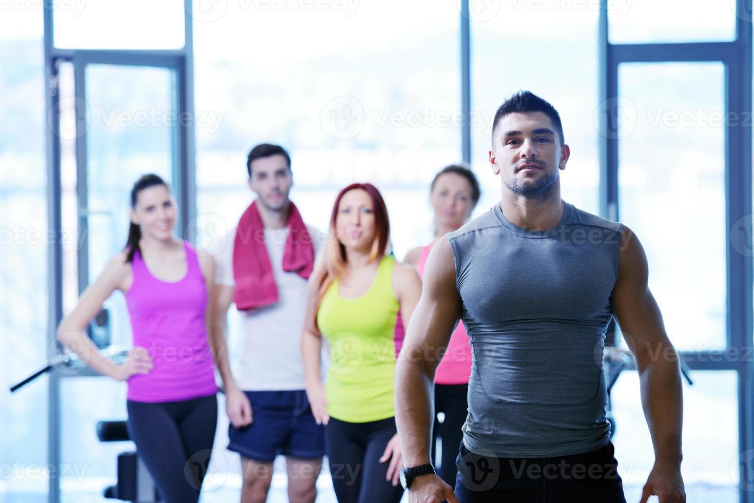 Group of people exercising at the gym photo