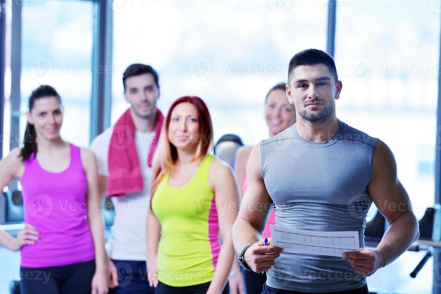 Group of people exercising at the gym photo