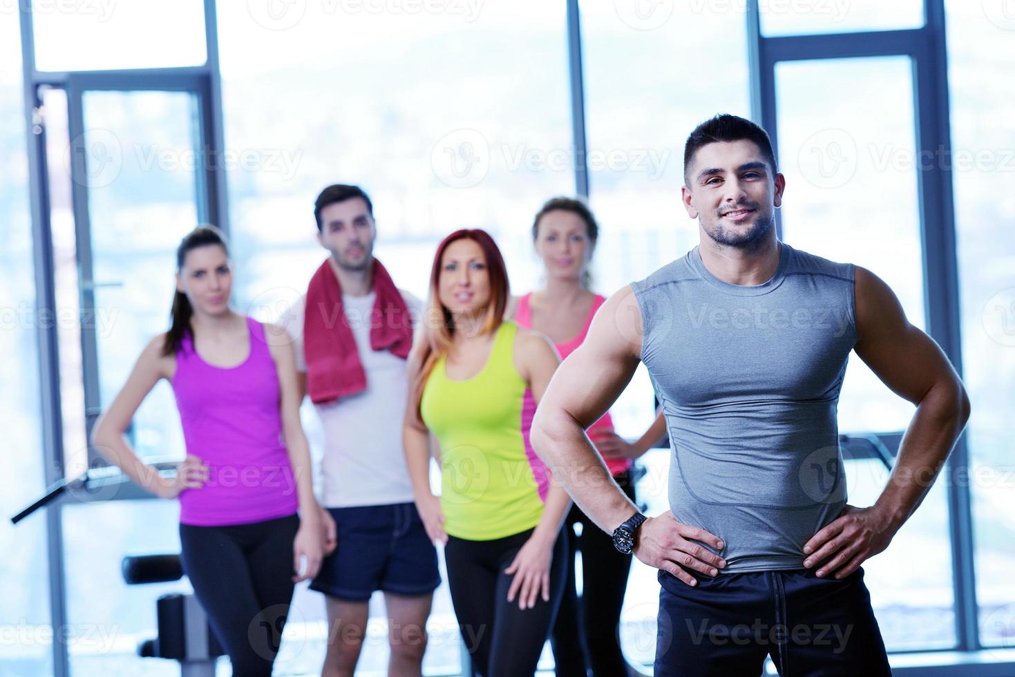 Group of people exercising at the gym photo