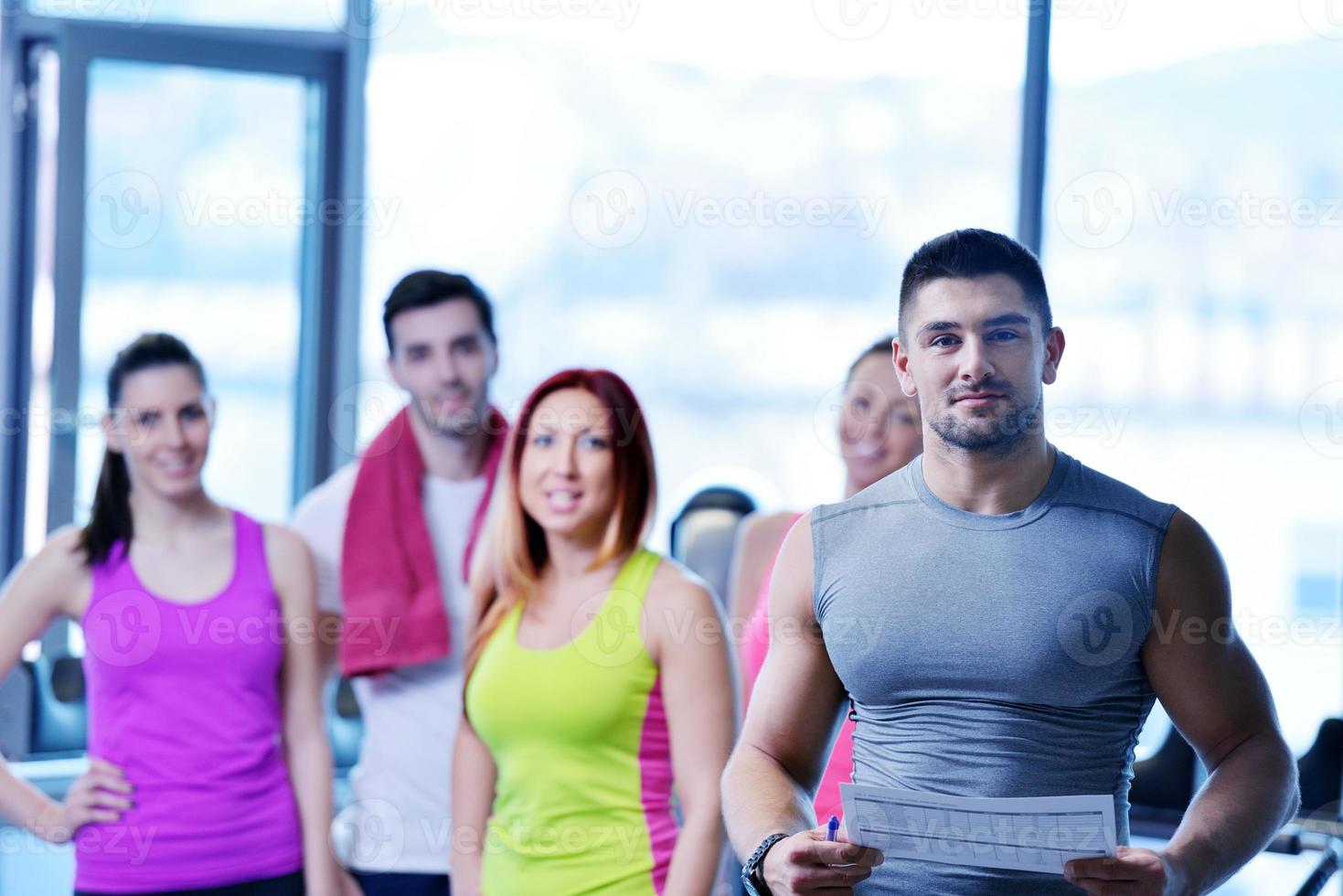 Group of people exercising at the gym photo