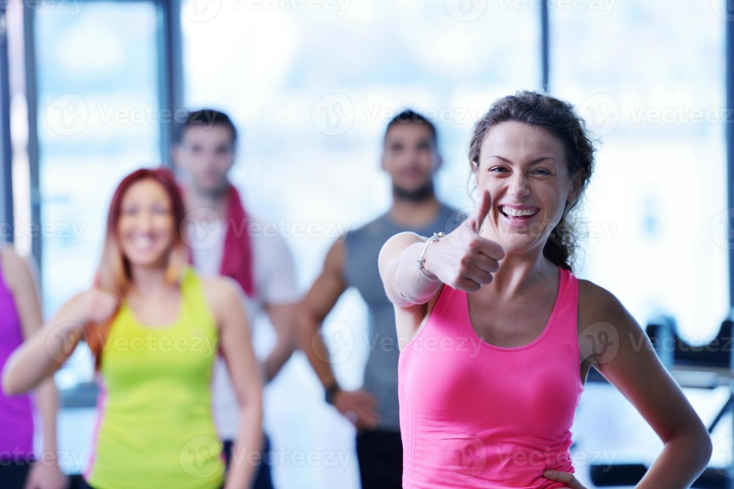 Group of people exercising at the gym photo