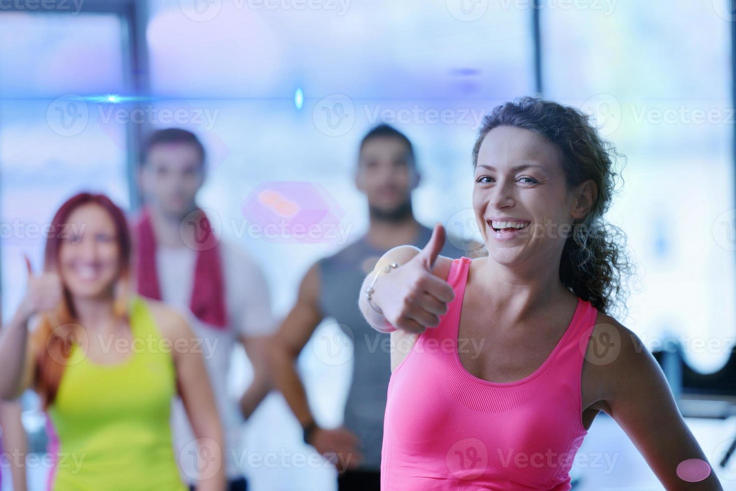 Group of people exercising at the gym photo