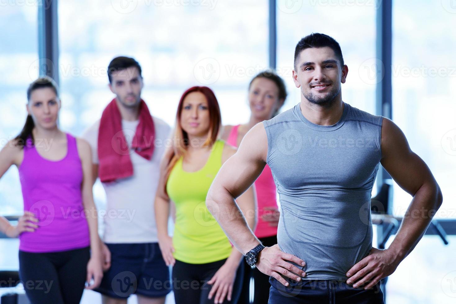 Group of people exercising at the gym photo