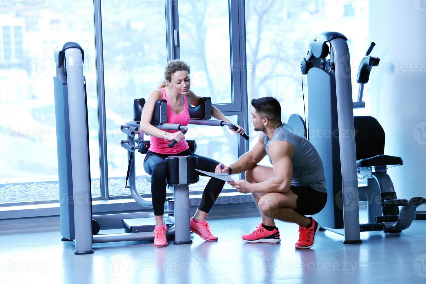 woman exercising with her personal trainer photo
