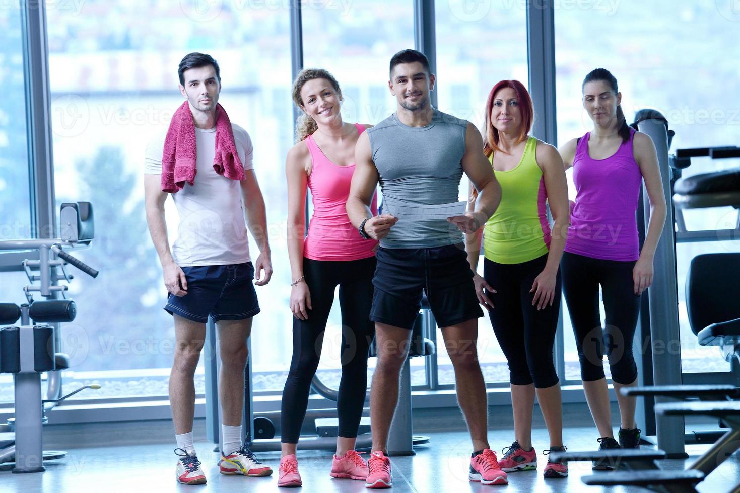 Group of people exercising at the gym photo