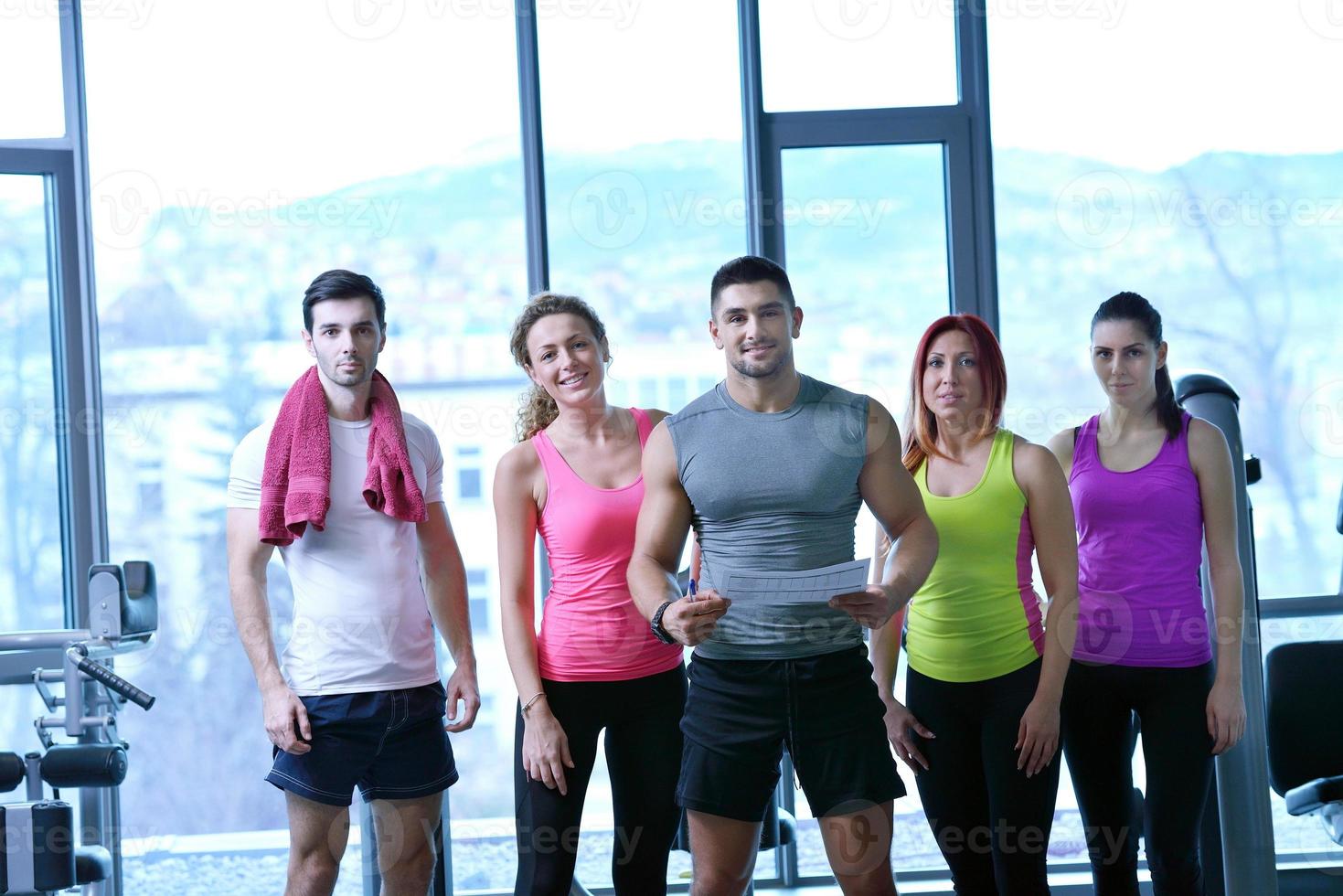 Group of people exercising at the gym photo