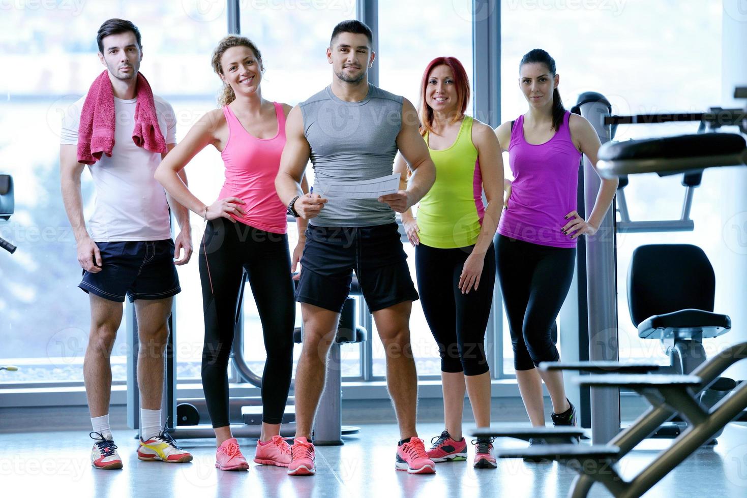 Group of people exercising at the gym photo