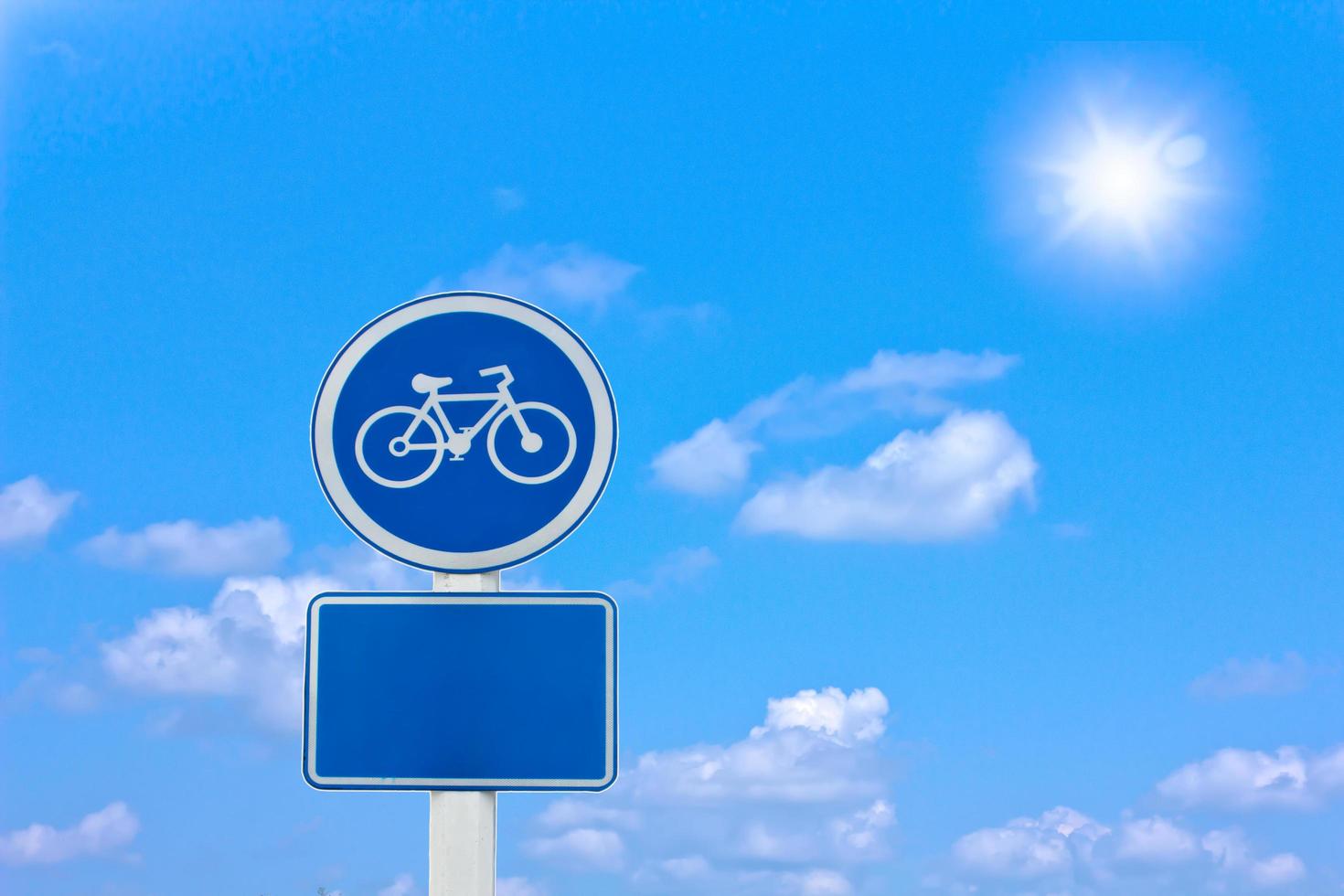 roadside bicycle sign on a cloudy background photo