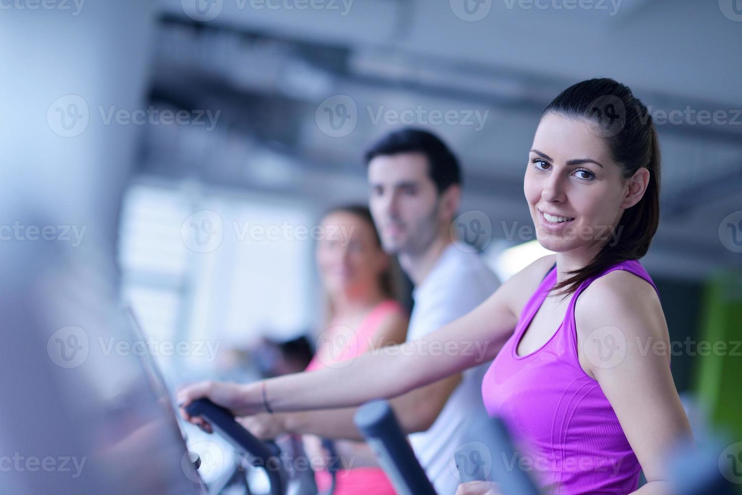 Group of people running on treadmills photo