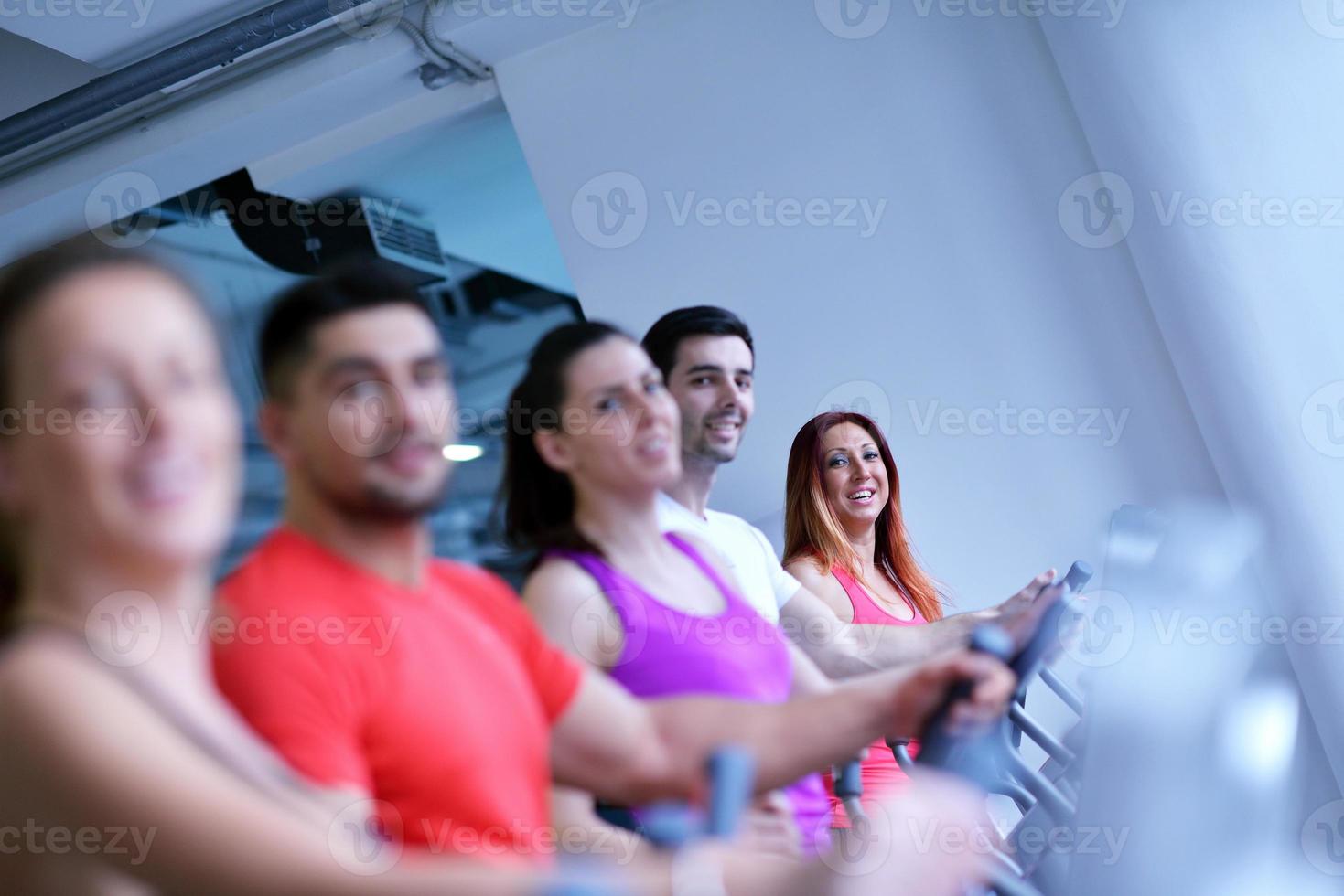 Group of people running on treadmills photo