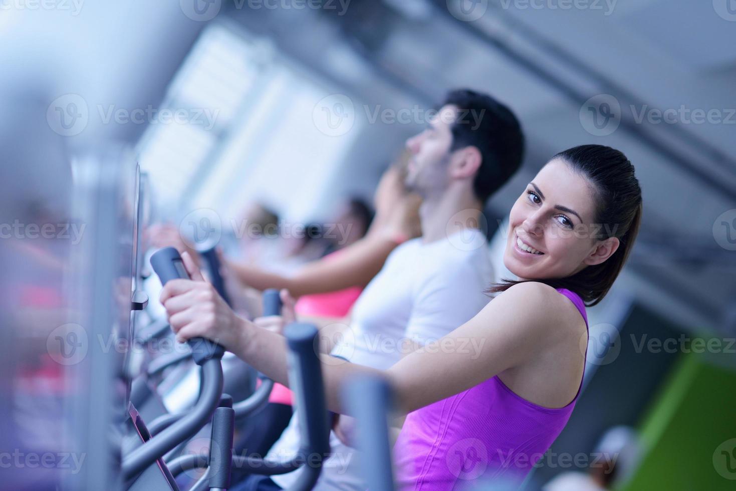 Group of people running on treadmills photo
