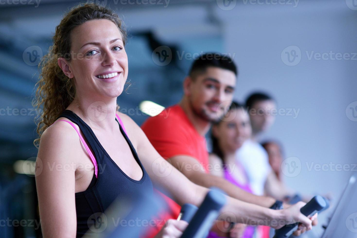 Group of people running on treadmills photo