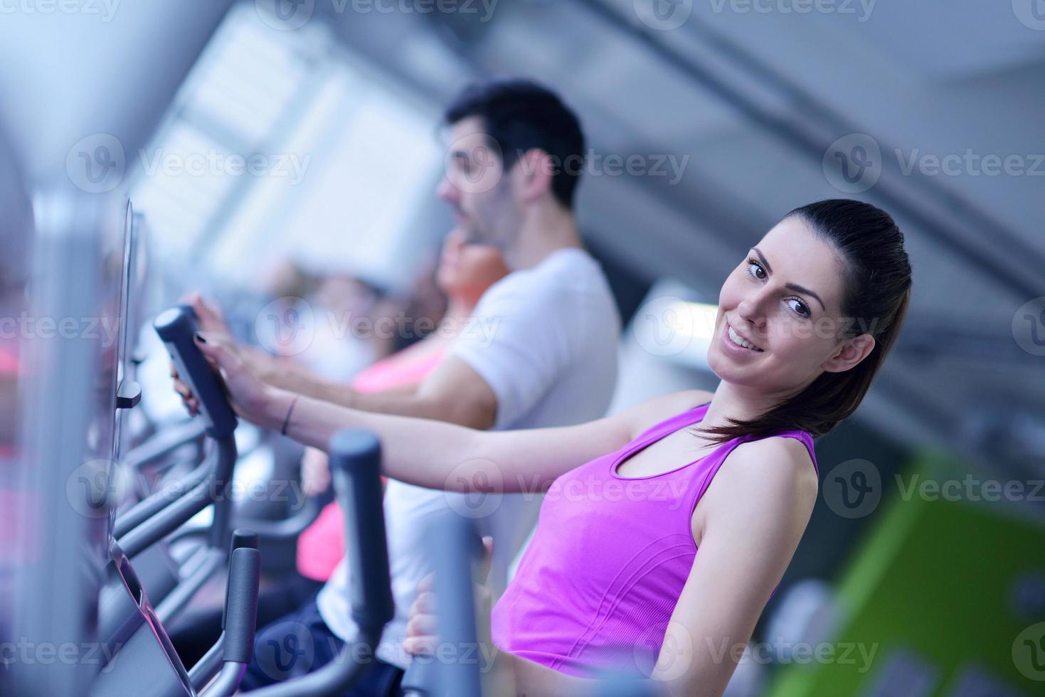 Group of people running on treadmills photo