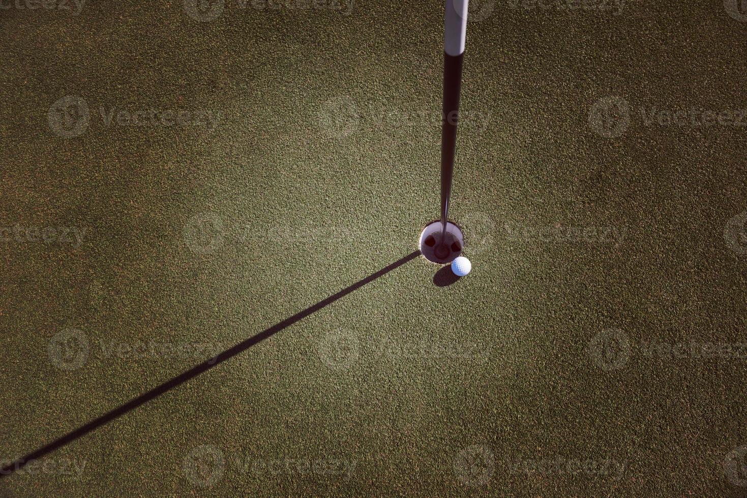 top view of golf ball in the hole photo