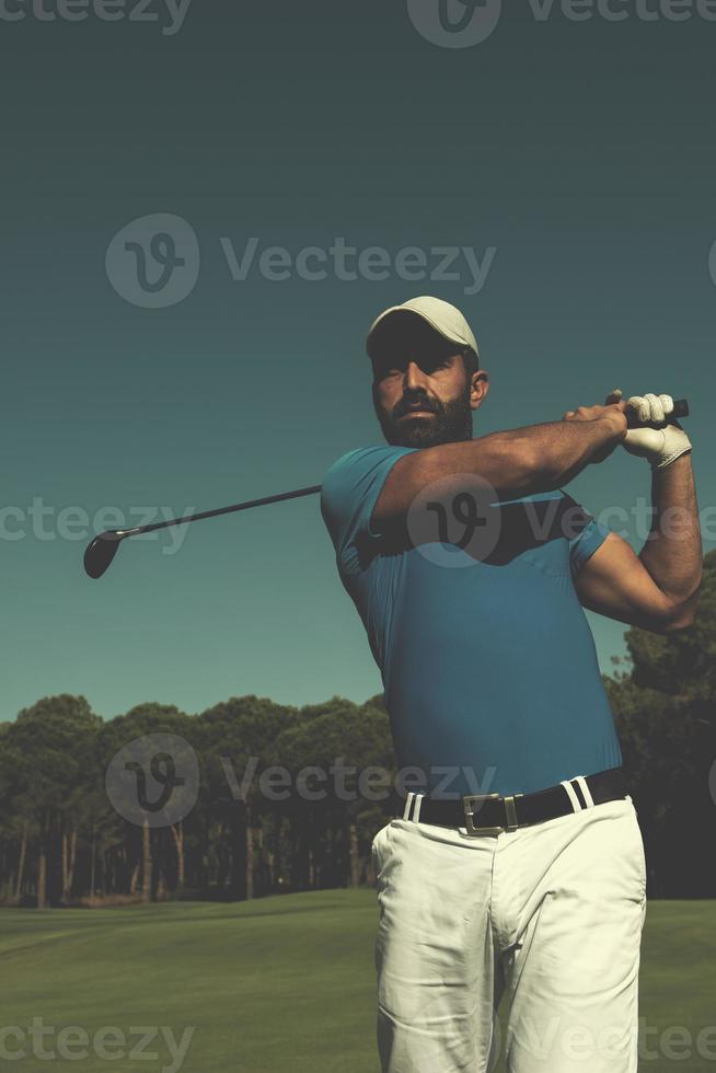 golf player hitting shot photo