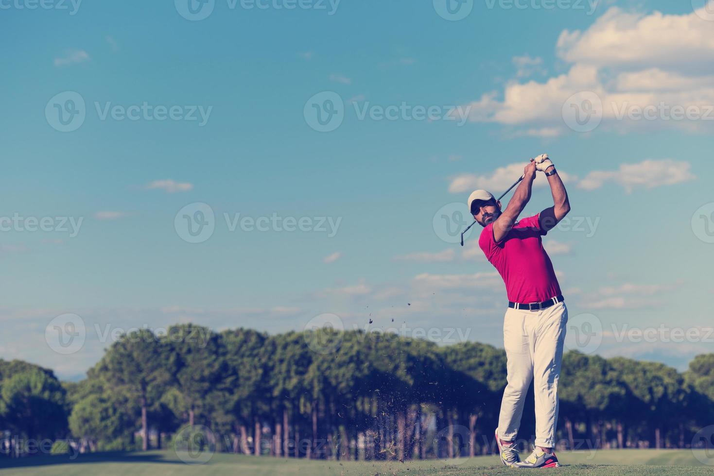 golf player hitting long shot photo