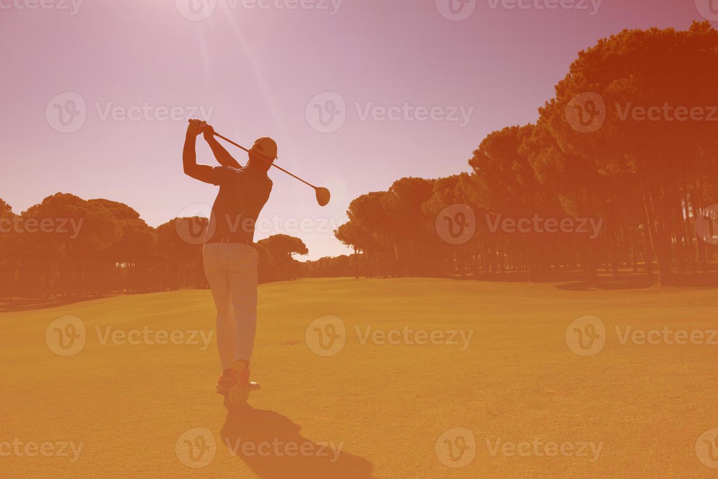 golf player hitting long shot photo