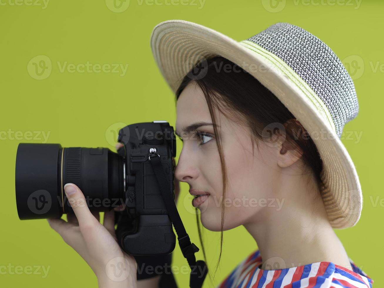 Portrait of beautiful female photographer shooting close up photo