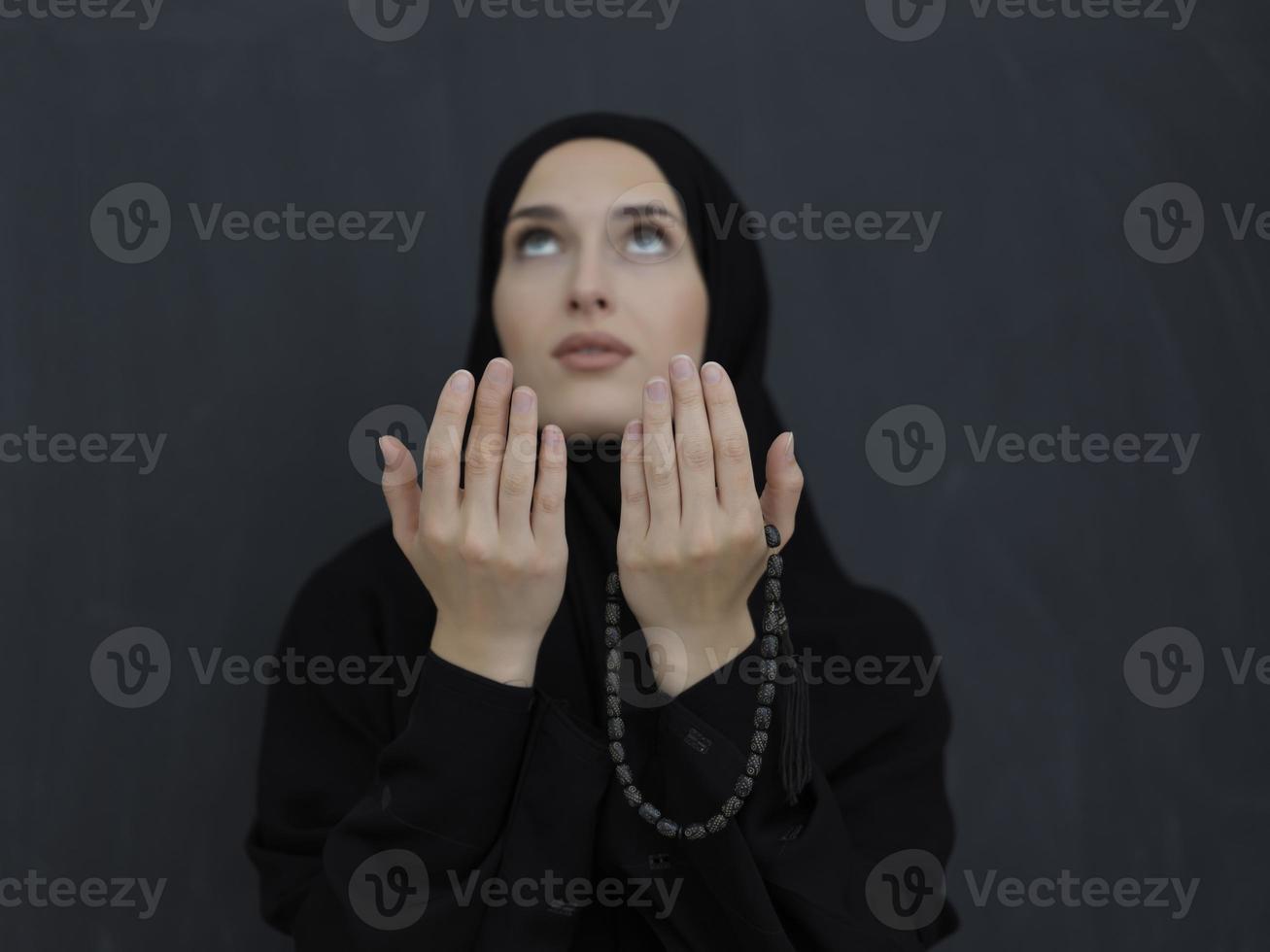 Portrait of young Muslim woman making dua photo