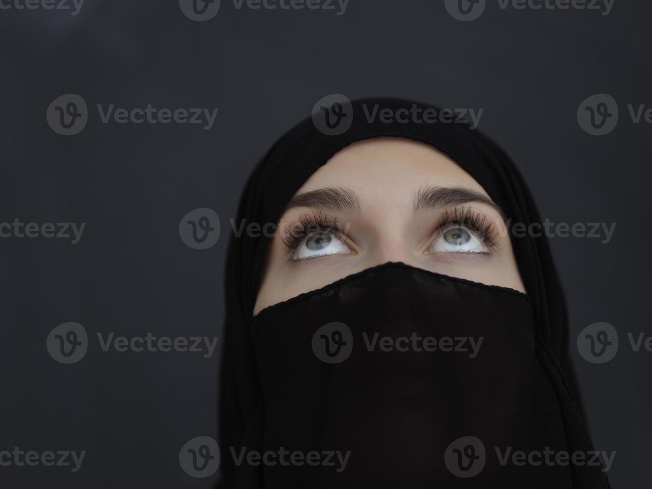 Portrait of muslim woman wearing niqab and traditional arabic clothes or abaya photo