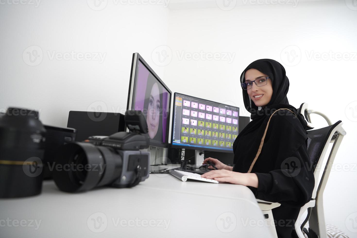 Young muslim girl working on the computer from home photo