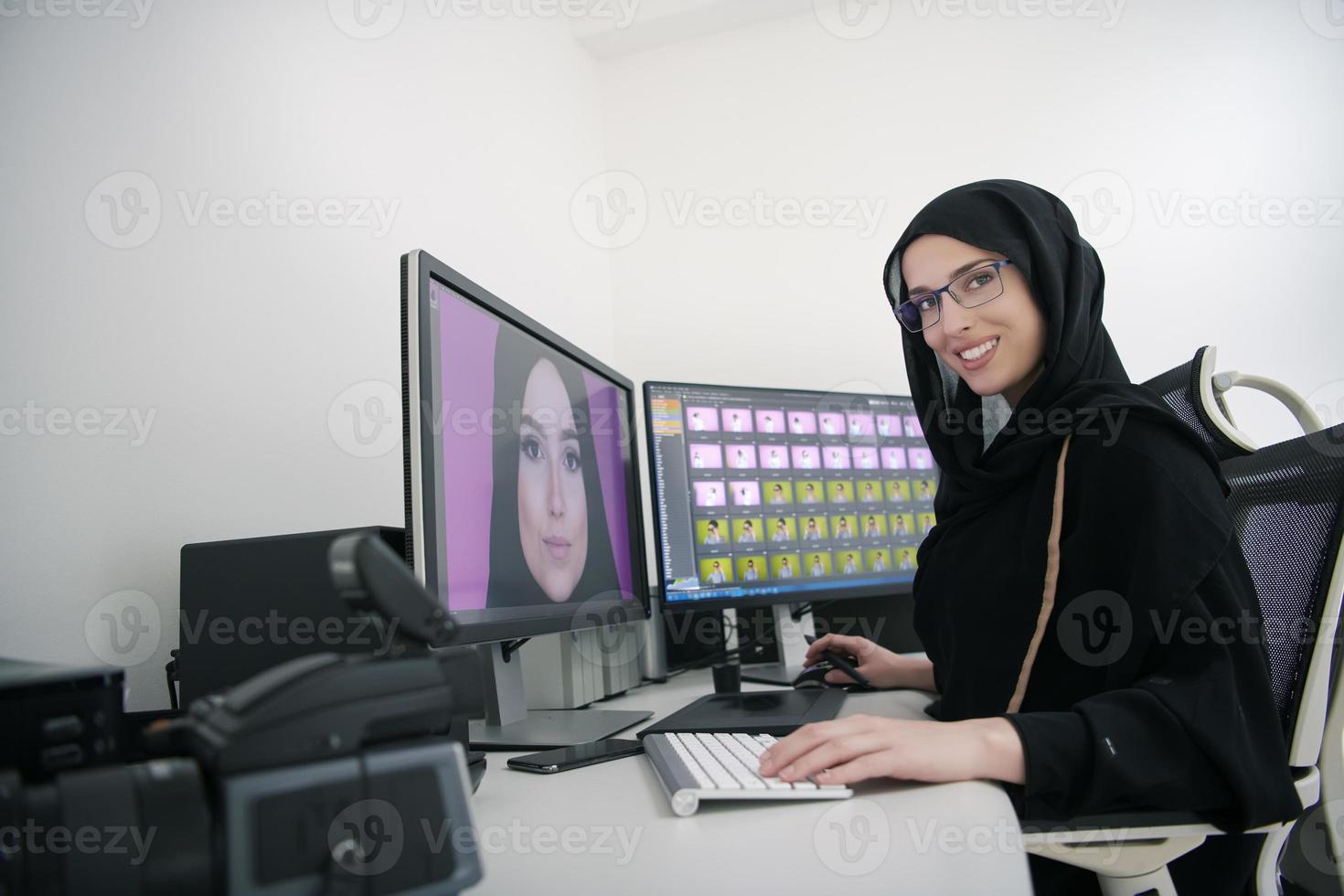 Young muslim girl working on the computer from home photo