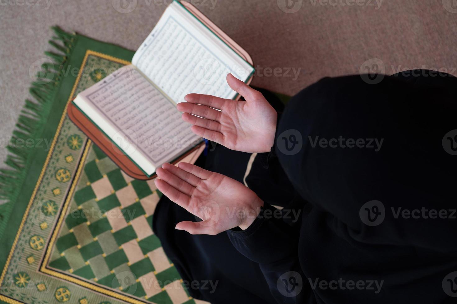 Middle eastern woman praying and reading the holy Quran Sarajevo photo