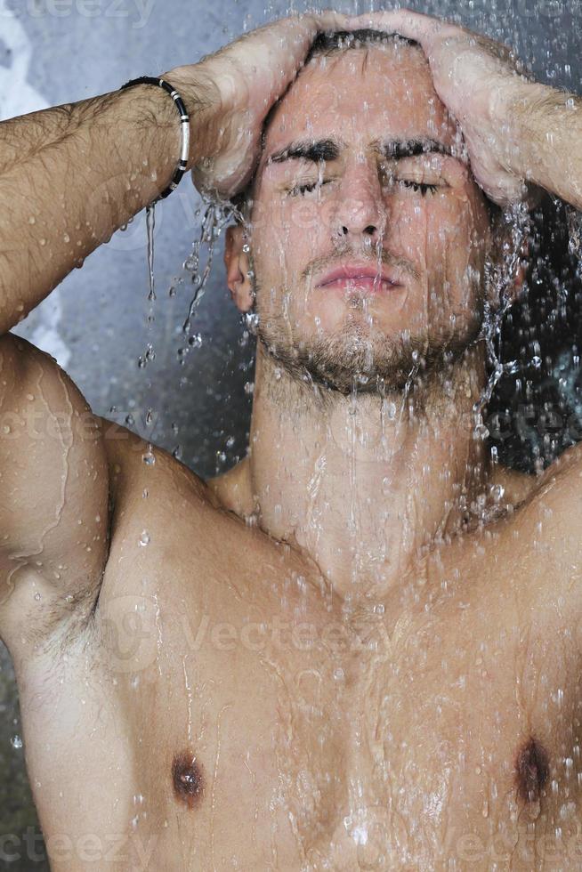 good looking man under man shower photo