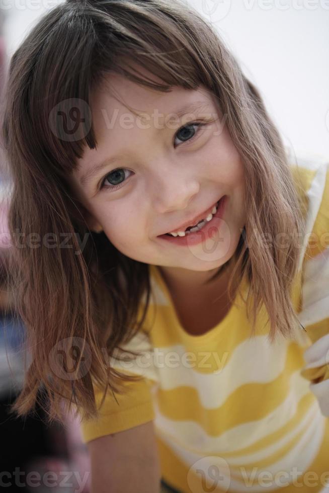 cute little girl at home painting with hands photo