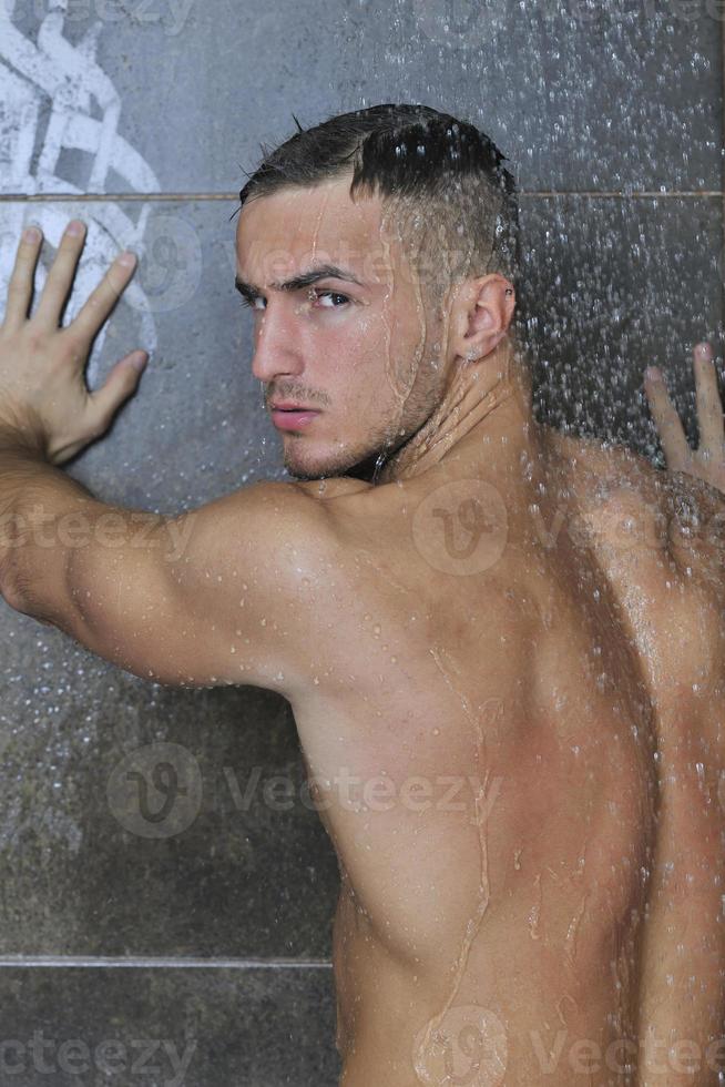 good looking man under man shower photo