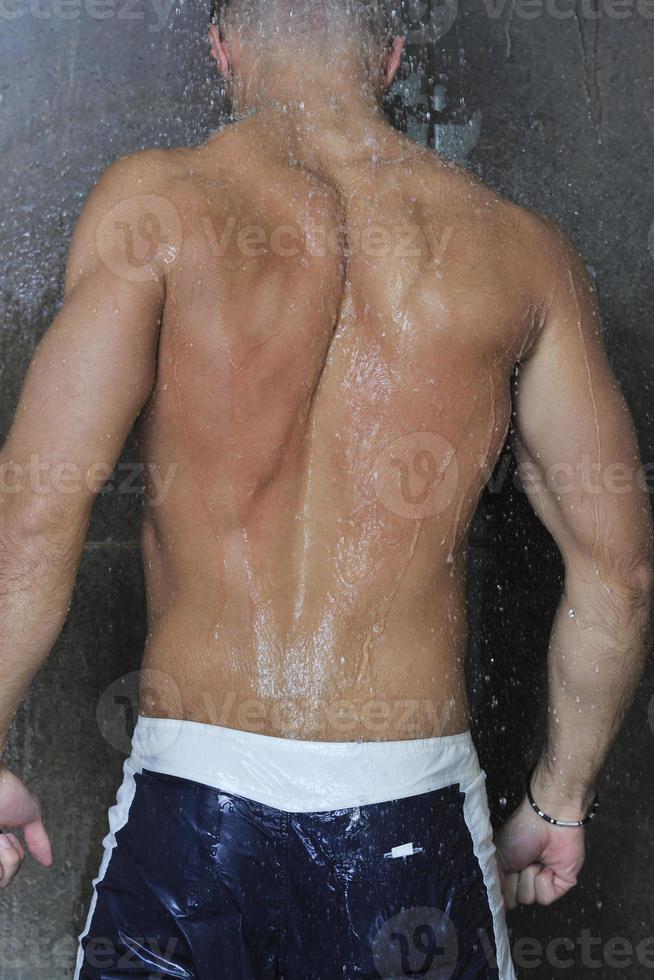 good looking man under man shower photo