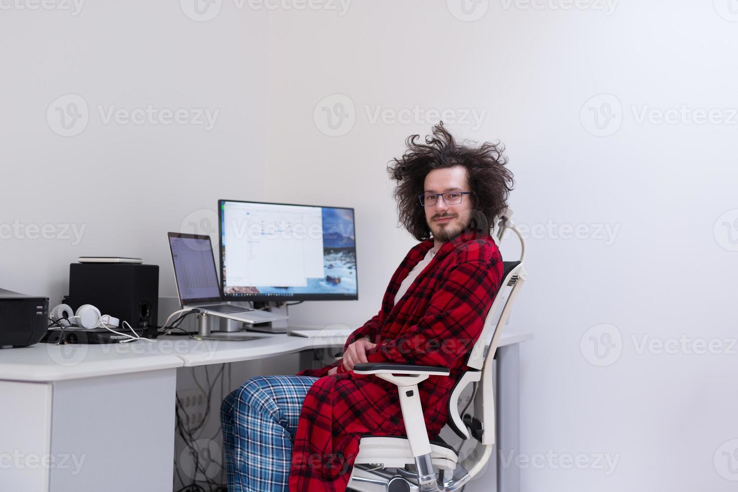 graphic designer in bathrobe working at home photo