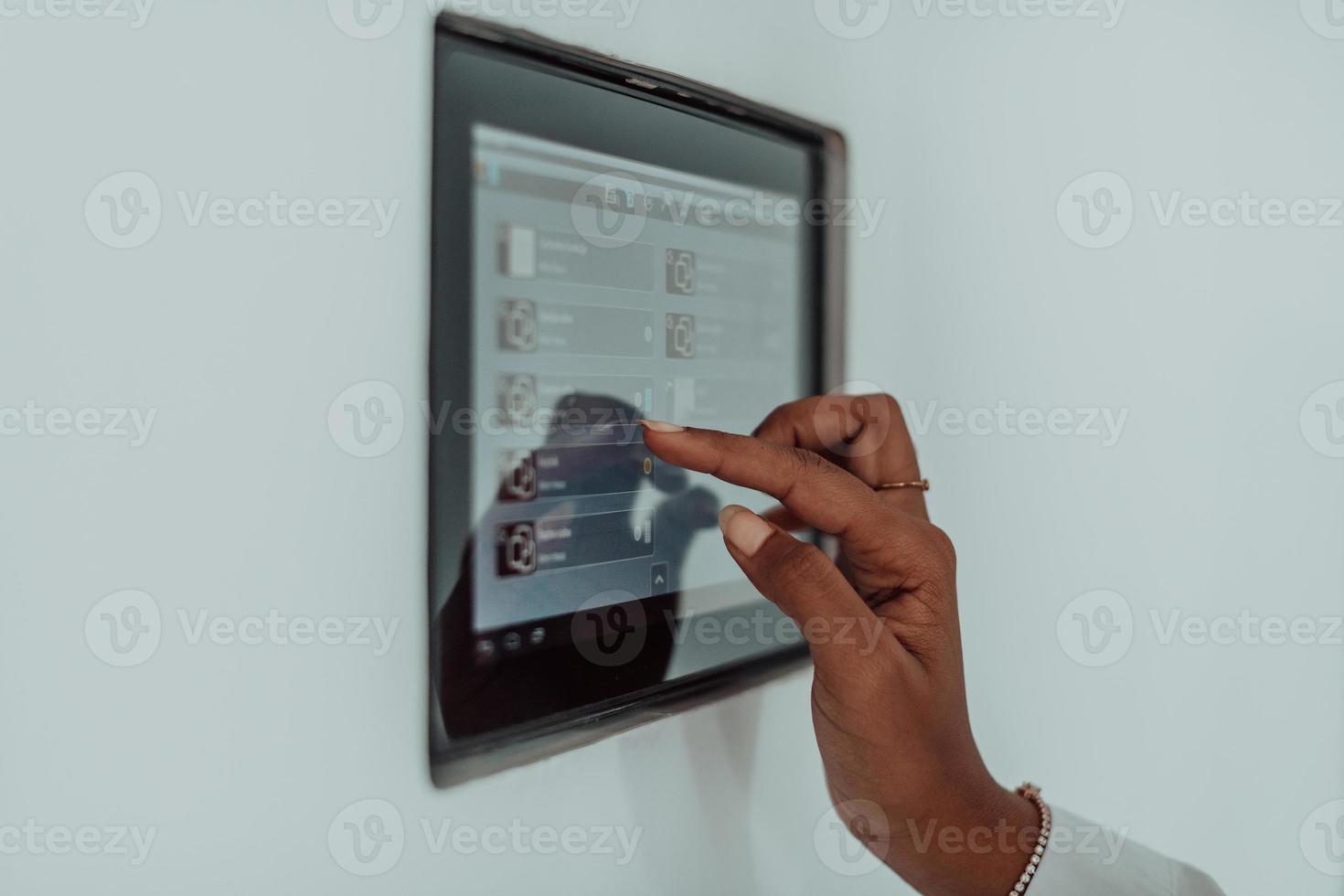 African woman using smart home screen control system photo