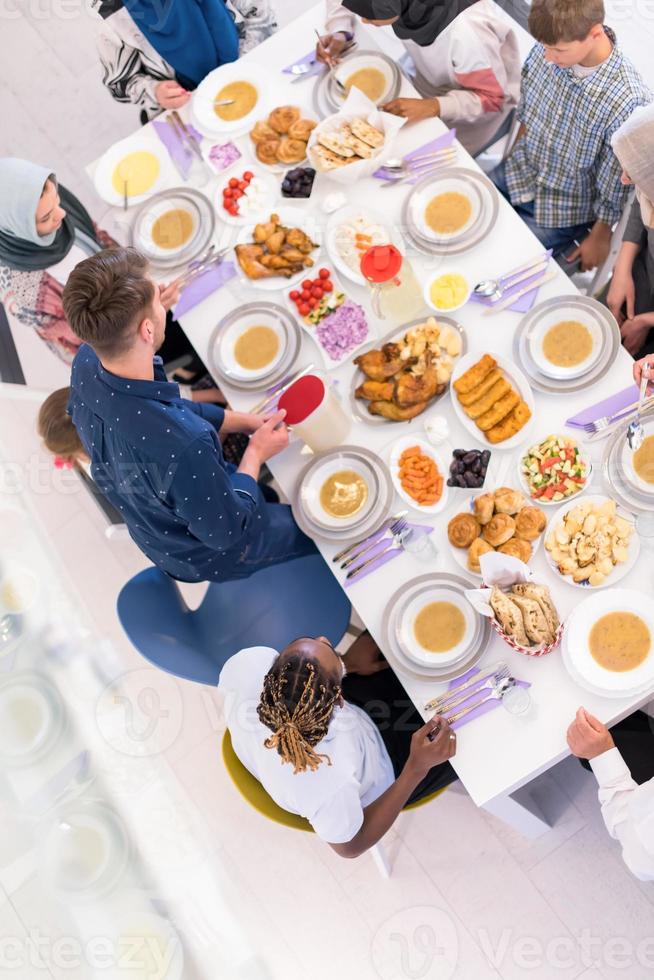 top view of modern multiethnic muslim family waiting for the beginning of iftar dinner photo