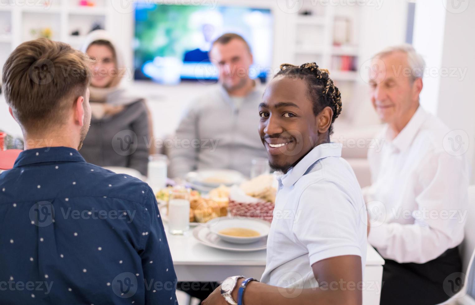 black man enjoying iftar dinner with family photo