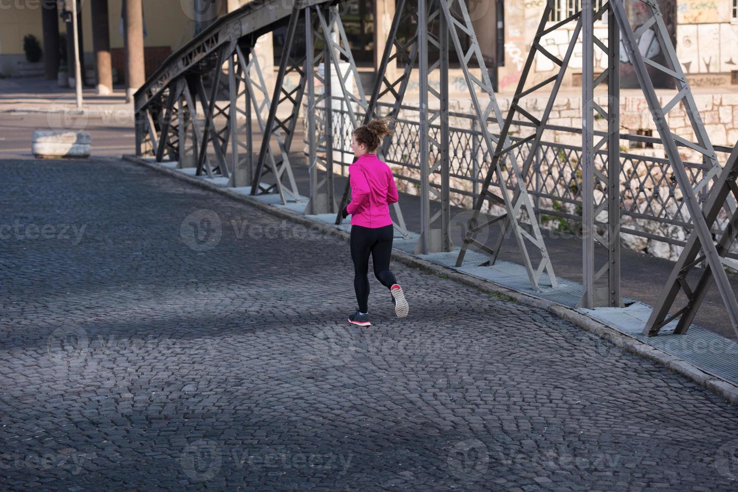 sporty woman jogging on morning photo