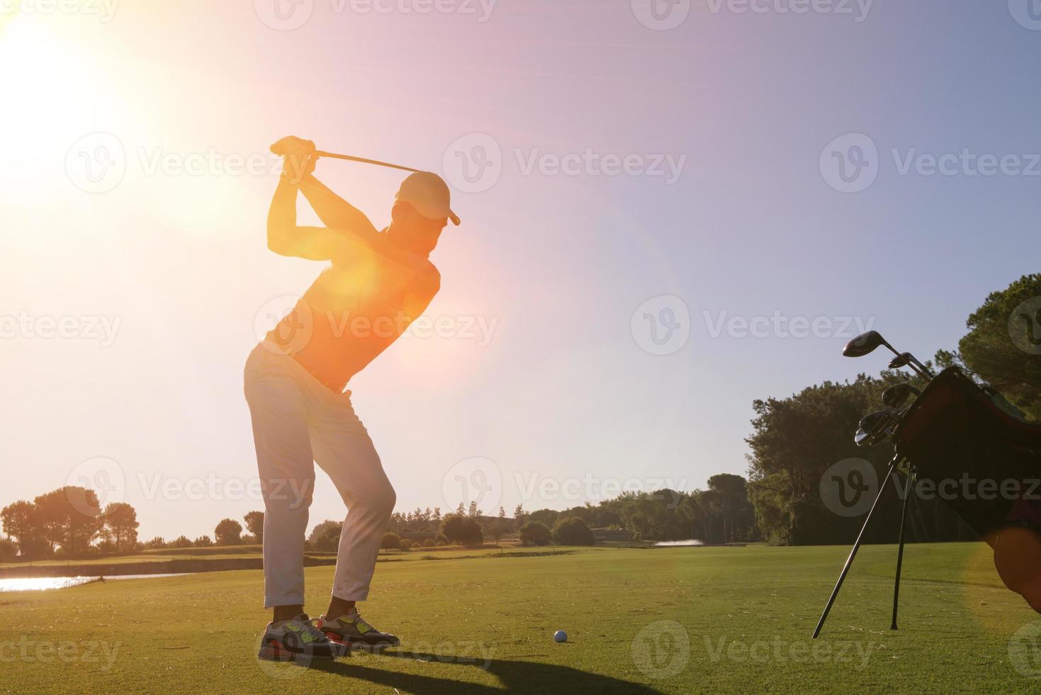 golf player hitting shot with club photo