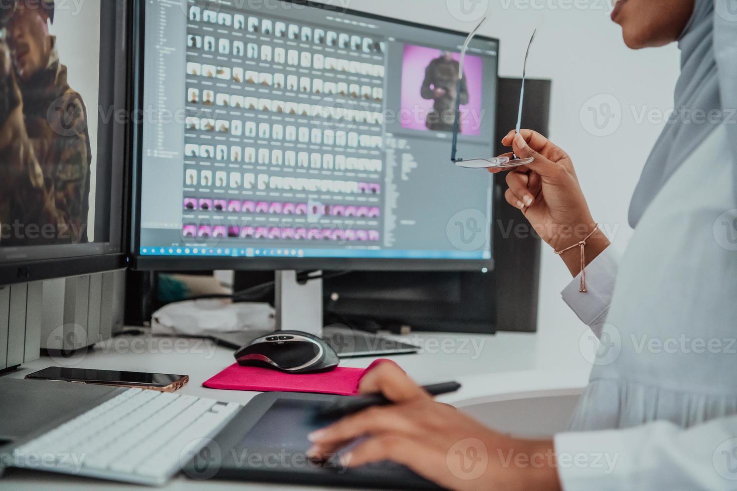 Young Afro-American modern Muslim businesswoman wearing a scarf in a creative bright office workplace with a big screen. photo