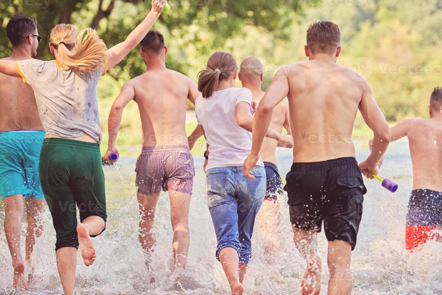 group of happy friends having fun on river photo