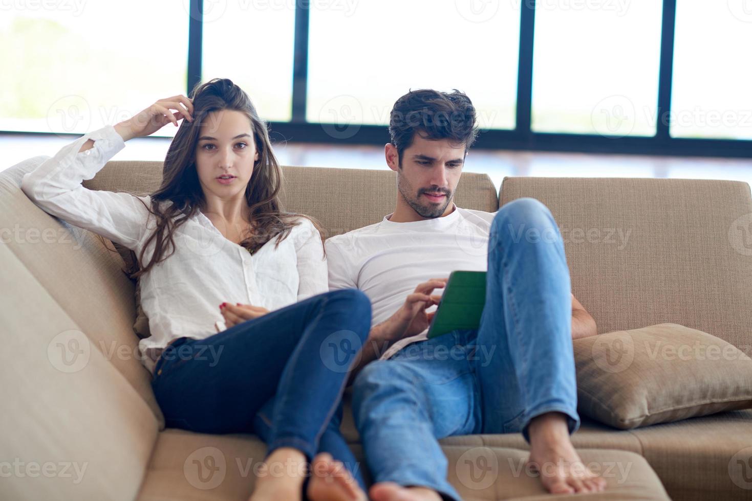 couple at modern home using tablet computer photo