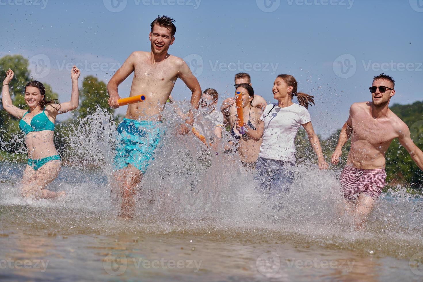 group of happy friends having fun on river photo
