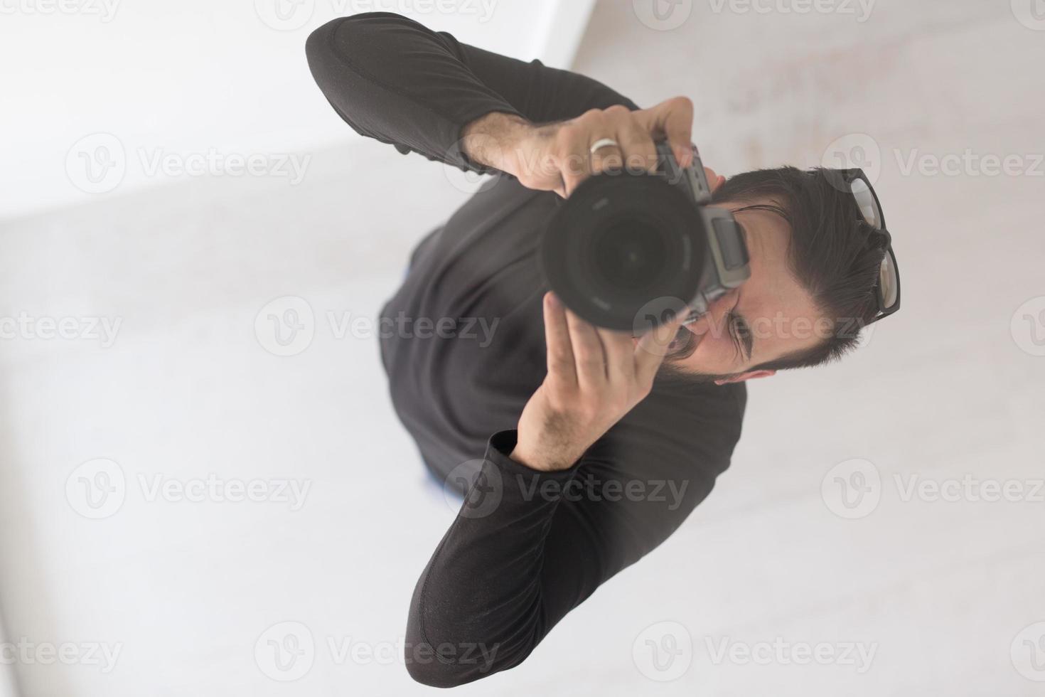 young Photographer takes pictures with DSLR camera photo