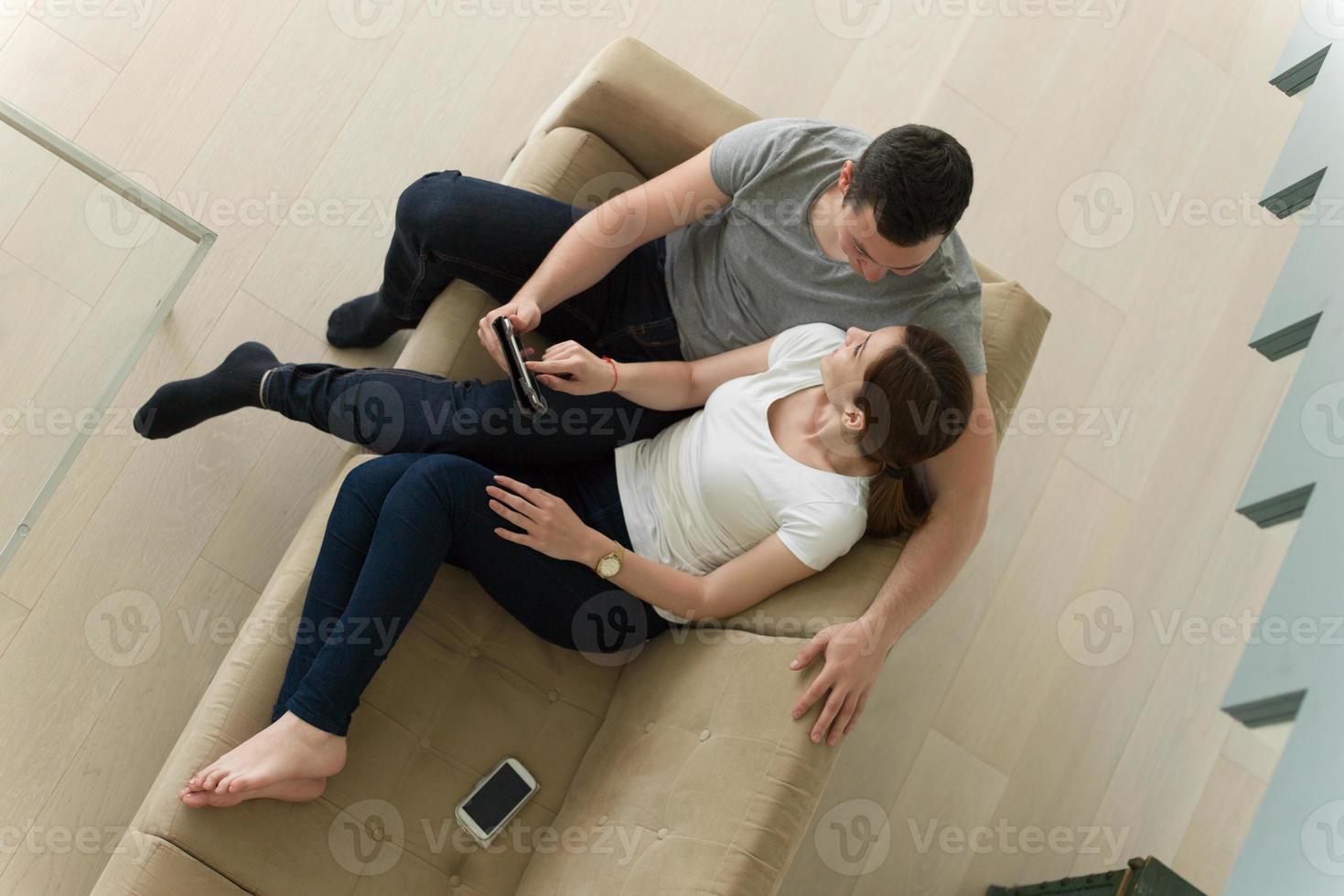 pareja relajándose en casa con tabletas foto