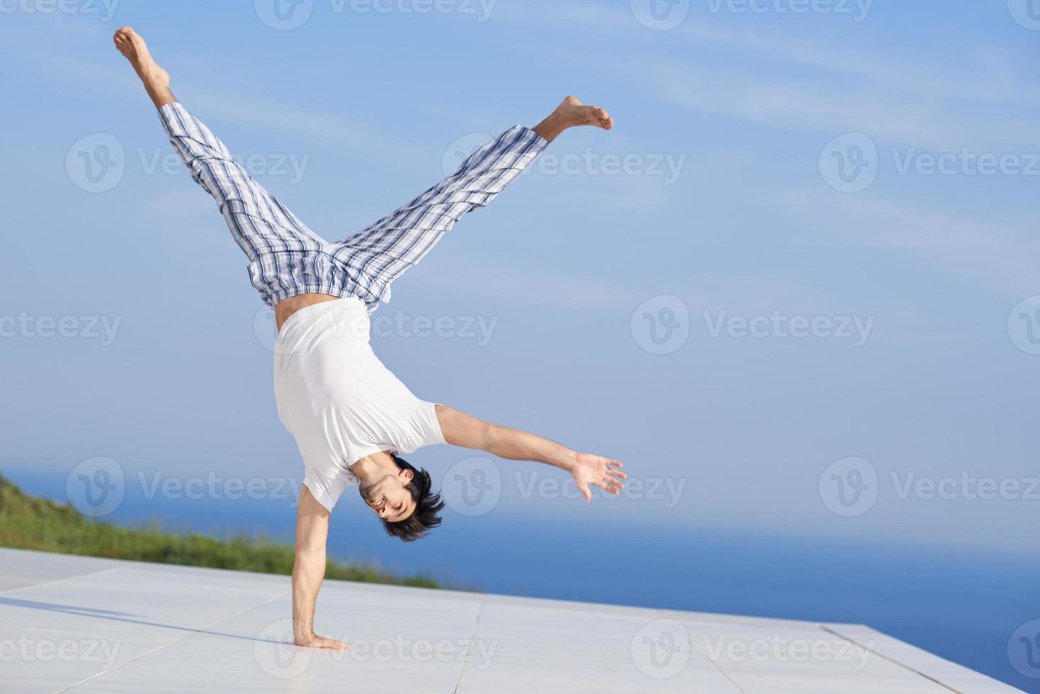 young man practicing yoga photo