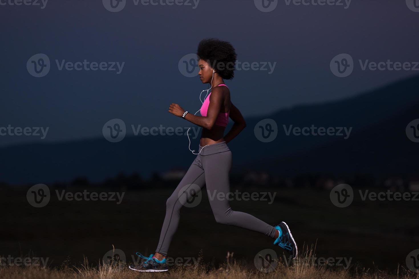 Young African american woman jogging in nature photo