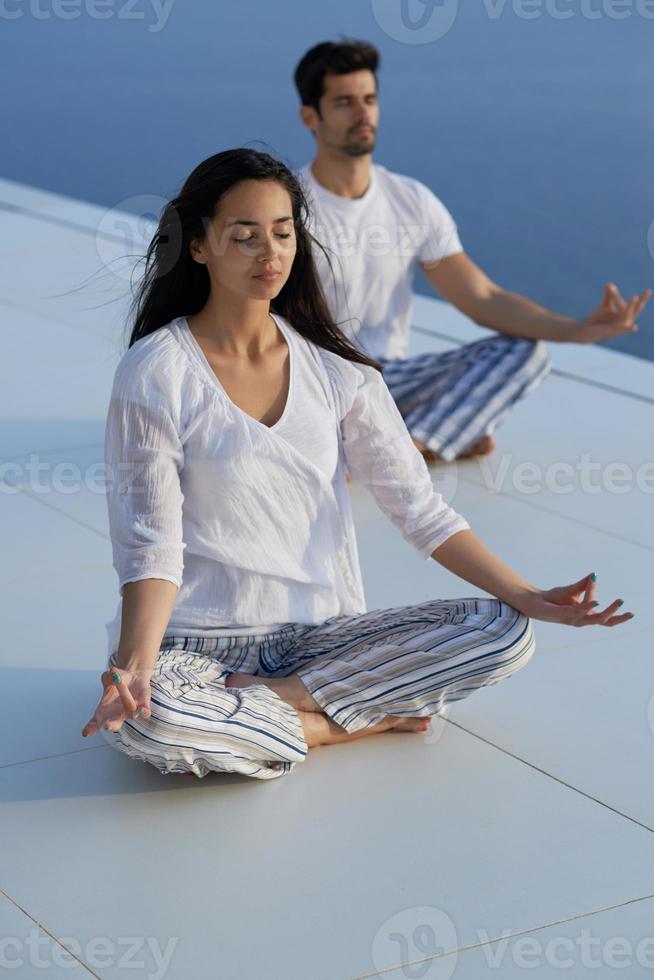 young couple practicing yoga photo